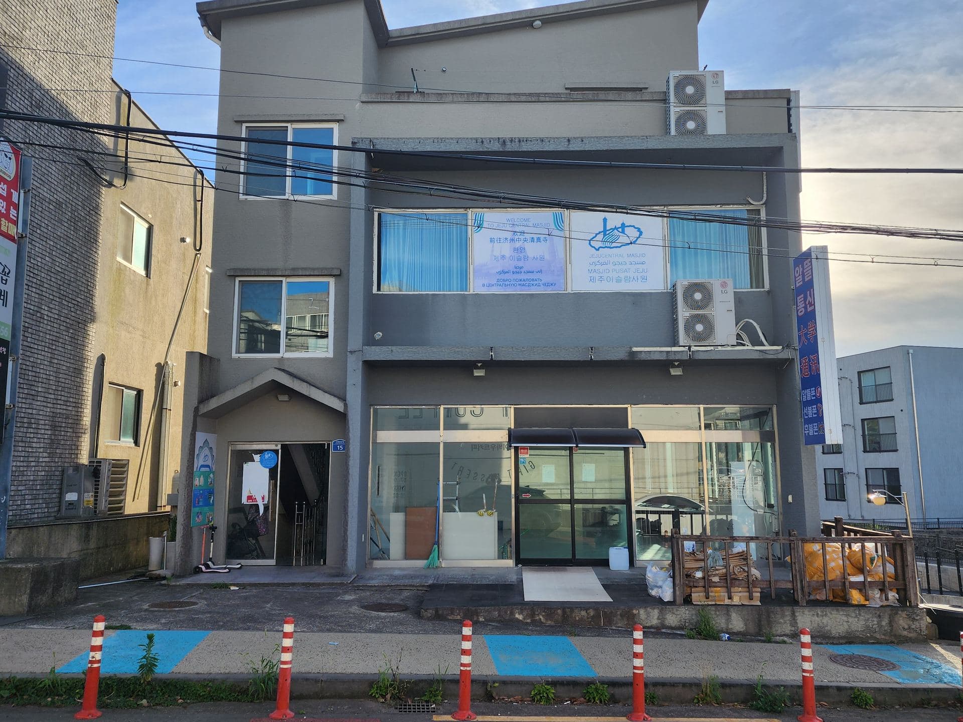The Jeju Central Masjid building — grey three-storey building with multilingual welcome signs on the 2nd-floor windows